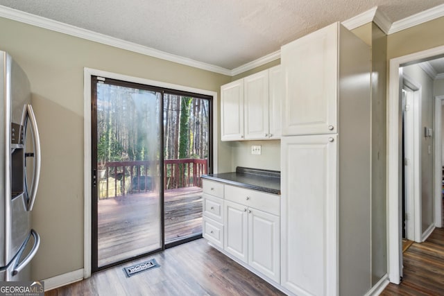 kitchen featuring a textured ceiling, white cabinetry, dark hardwood / wood-style floors, and stainless steel refrigerator with ice dispenser