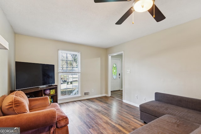 living room featuring hardwood / wood-style flooring and ceiling fan