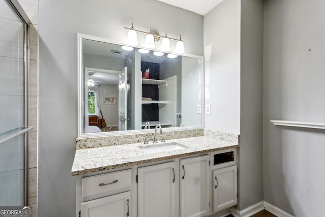 bathroom with ceiling fan and vanity