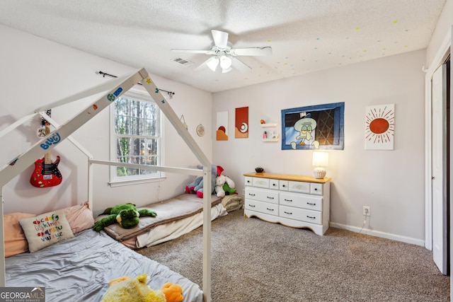 bedroom featuring a textured ceiling, ceiling fan, and carpet