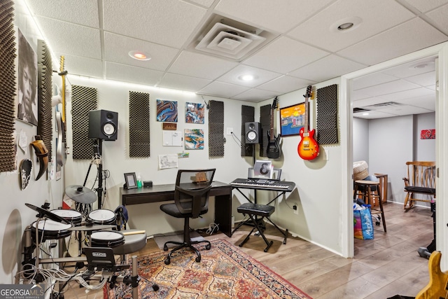 office space with a paneled ceiling and hardwood / wood-style flooring