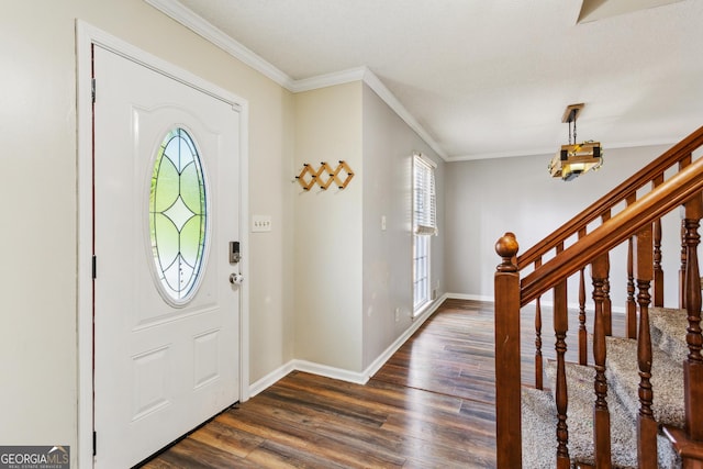 foyer entrance with dark hardwood / wood-style flooring and crown molding