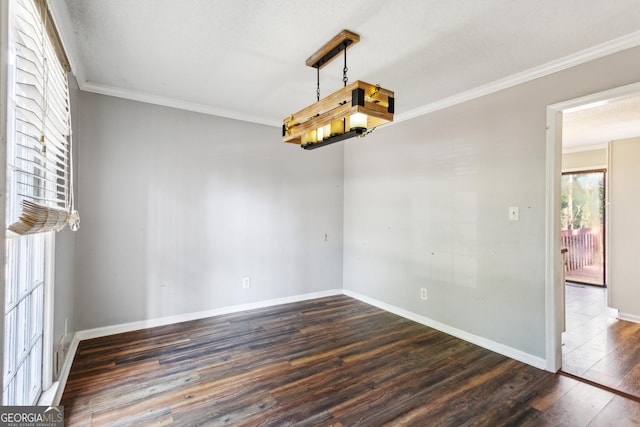 unfurnished dining area with ornamental molding and dark hardwood / wood-style floors