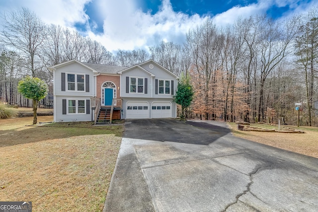 bi-level home with a garage and a front yard