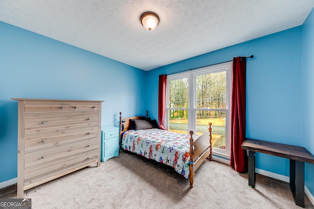 bedroom featuring a textured ceiling and carpet