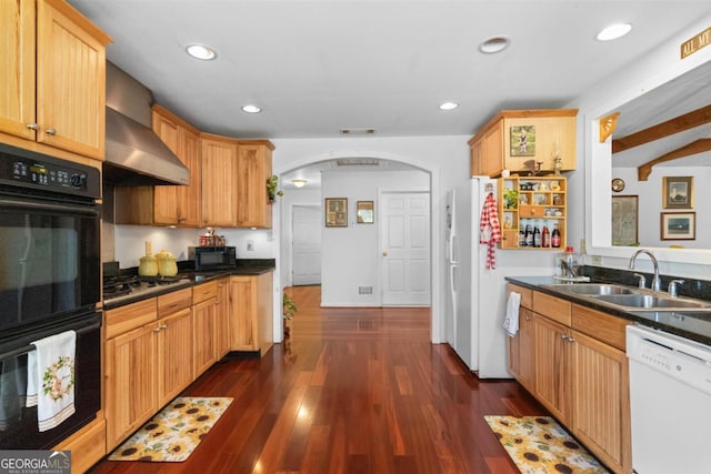 kitchen with black appliances, dark wood-type flooring, beam ceiling, sink, and wall chimney range hood