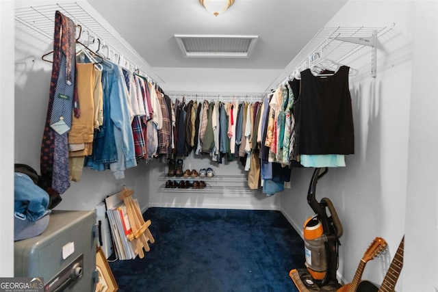 walk in closet with carpet