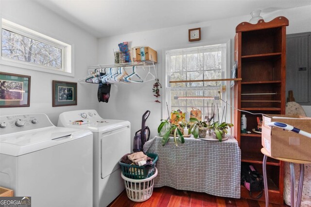 washroom featuring a healthy amount of sunlight, washer and clothes dryer, hardwood / wood-style flooring, and electric panel