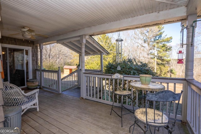 wooden terrace featuring ceiling fan