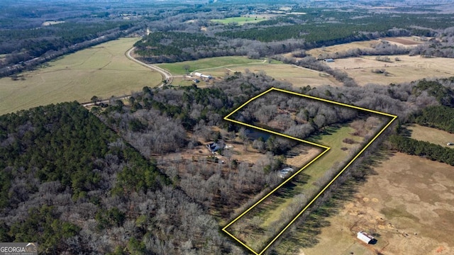 birds eye view of property with a rural view