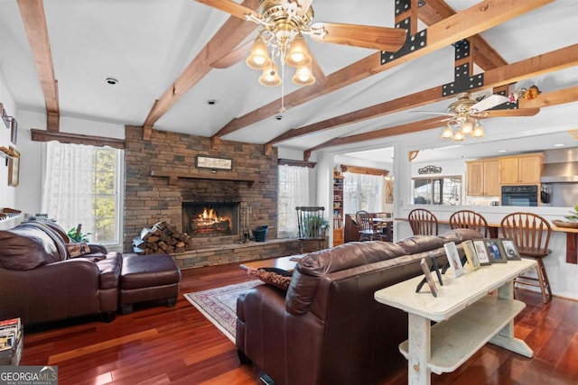 living room with a fireplace, ceiling fan, lofted ceiling with beams, and dark hardwood / wood-style floors