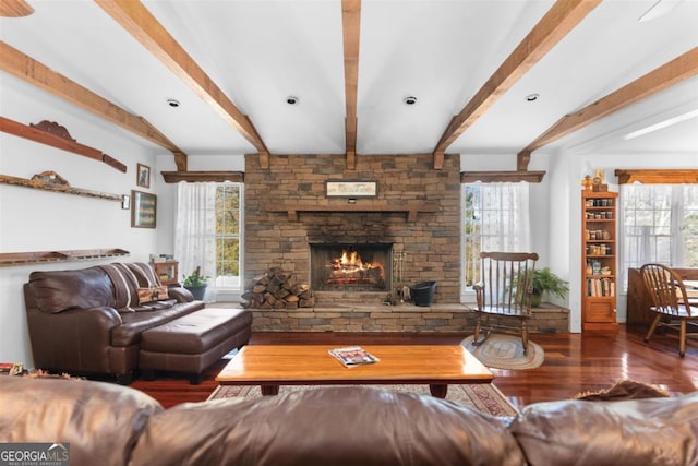 living room featuring hardwood / wood-style floors, plenty of natural light, beamed ceiling, and a fireplace