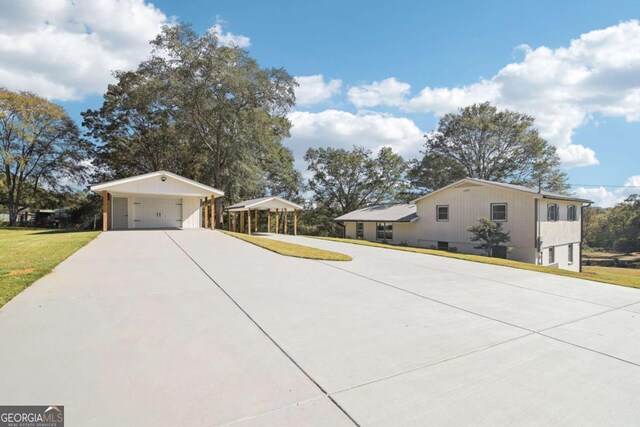 view of side of property with a lawn and a carport