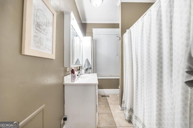 bathroom featuring vanity, tile patterned flooring, and ornamental molding