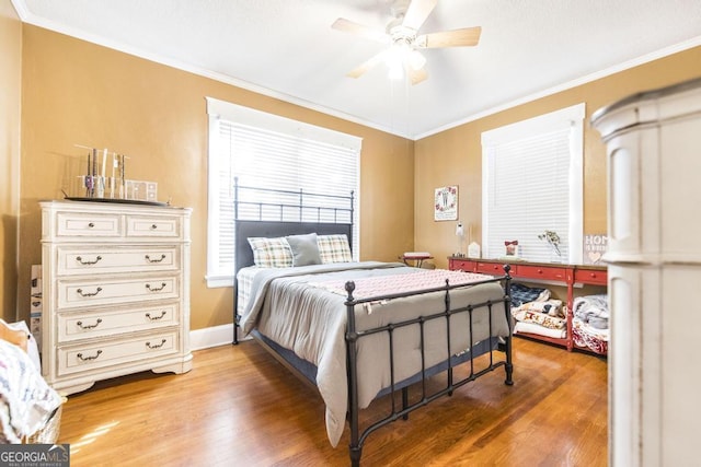 bedroom featuring ceiling fan, hardwood / wood-style flooring, and ornamental molding