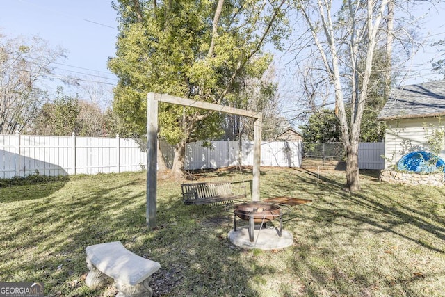 view of yard with an outdoor fire pit