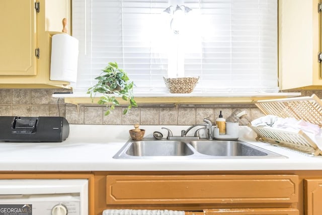 kitchen featuring sink and backsplash