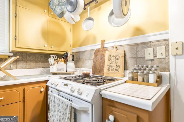 kitchen with white electric range and backsplash