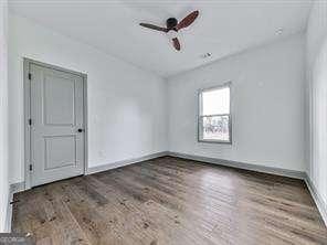 empty room featuring ceiling fan and hardwood / wood-style floors