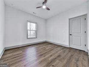 spare room with ceiling fan and dark hardwood / wood-style floors