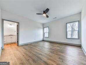 spare room with ceiling fan and wood-type flooring