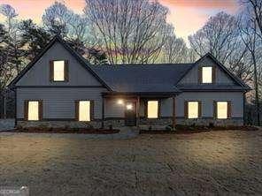 back house at dusk featuring a yard