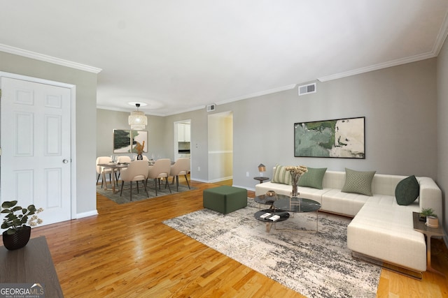 living room with ornamental molding and hardwood / wood-style floors