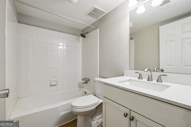 full bathroom with toilet, tiled shower / bath combo, and vanity