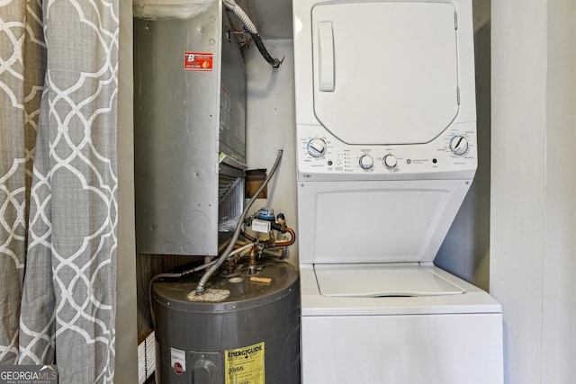 laundry area featuring water heater and stacked washer and clothes dryer