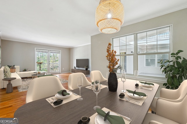 dining area with crown molding and hardwood / wood-style flooring