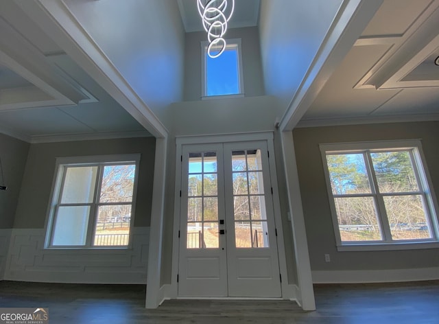 doorway with ornamental molding, dark wood-type flooring, and french doors