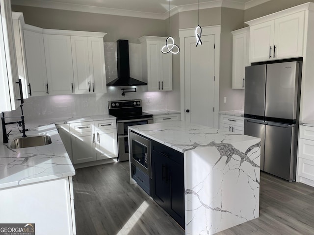 kitchen featuring a center island, white cabinetry, wall chimney exhaust hood, pendant lighting, and appliances with stainless steel finishes