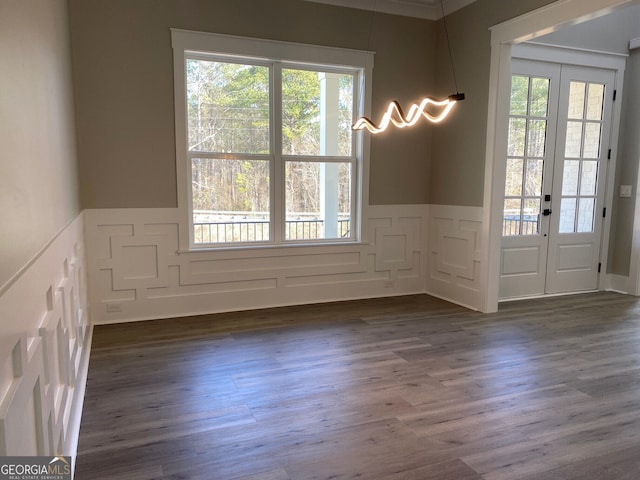 empty room with dark hardwood / wood-style flooring and french doors