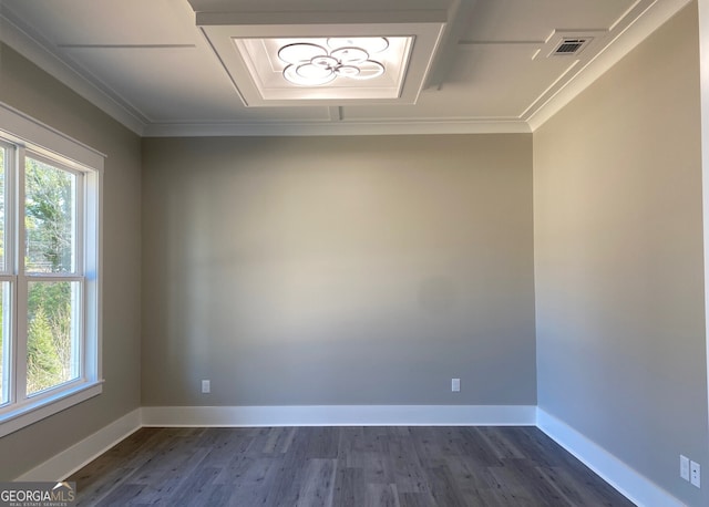 spare room featuring dark wood-type flooring and crown molding