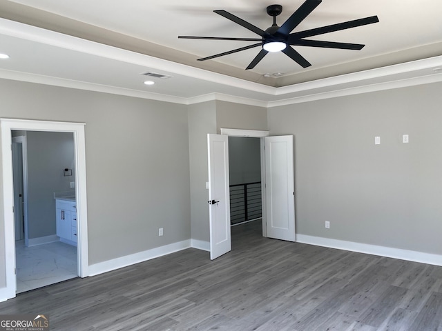 unfurnished bedroom with hardwood / wood-style floors, ornamental molding, ceiling fan, and connected bathroom