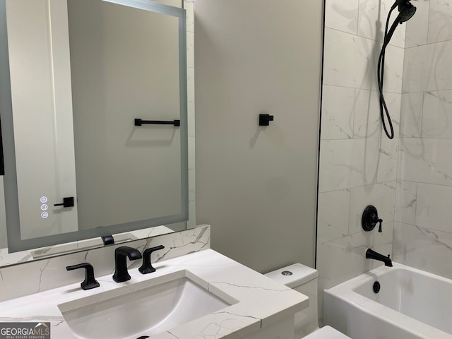 full bathroom with toilet, tiled shower / bath combo, and vanity