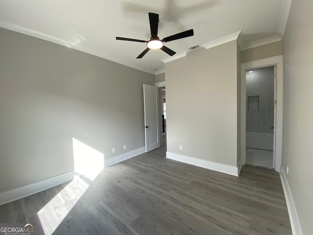 unfurnished bedroom with ceiling fan, ornamental molding, ensuite bath, and dark hardwood / wood-style floors