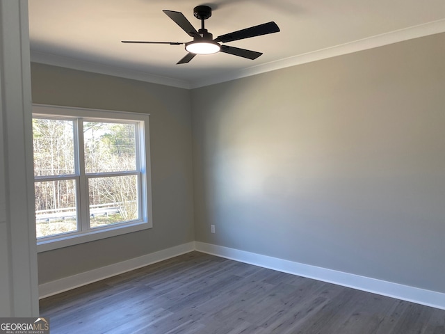 unfurnished room with ornamental molding, ceiling fan, and dark hardwood / wood-style floors