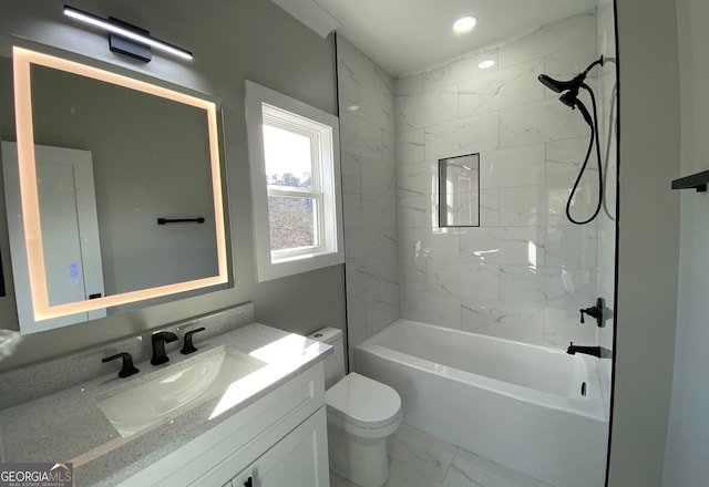 full bathroom with tiled shower / bath combo, vanity, and toilet