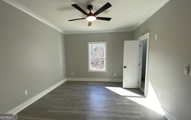 spare room featuring ornamental molding, ceiling fan, and dark hardwood / wood-style floors