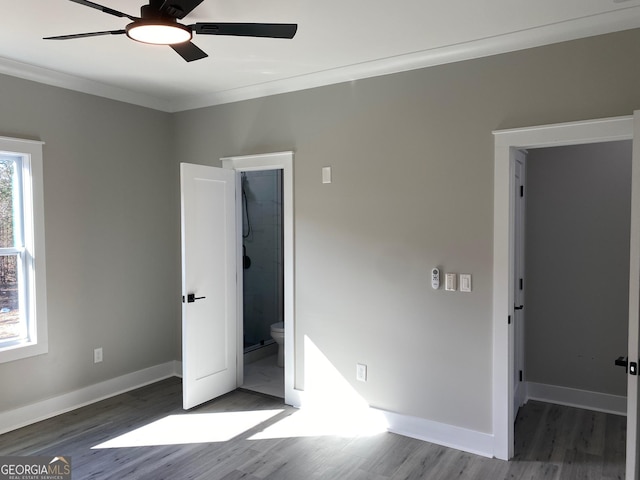 unfurnished bedroom with ensuite bathroom, ceiling fan, hardwood / wood-style flooring, and crown molding