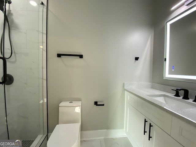 bathroom featuring a tile shower, vanity, and toilet