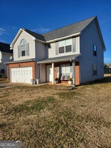 view of property with a front lawn and a garage