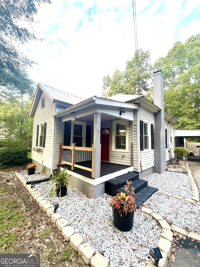 back of property with a porch