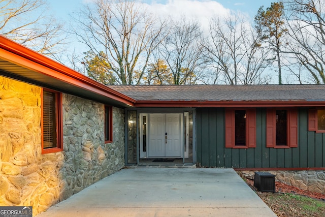 view of exterior entry with a patio area