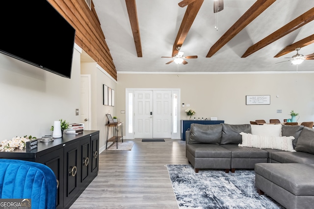 living room with lofted ceiling with beams and light wood-type flooring