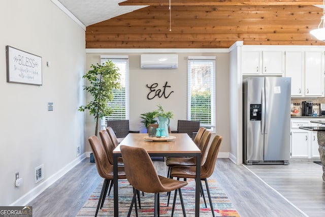 dining room with light hardwood / wood-style flooring, vaulted ceiling, and a wall mounted air conditioner