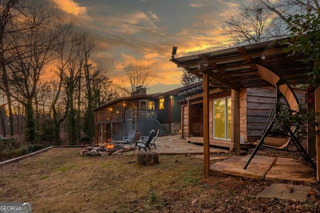 yard at dusk with a patio area and a fire pit