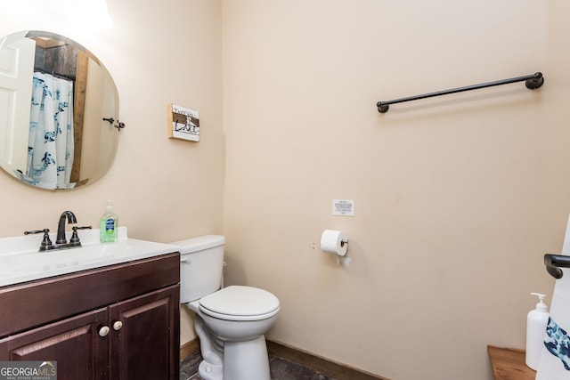 bathroom with toilet and vanity