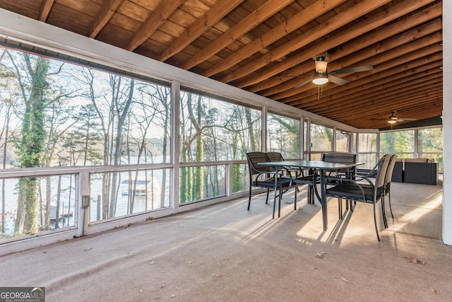 sunroom / solarium featuring ceiling fan, a wealth of natural light, lofted ceiling with beams, and wood ceiling